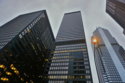 Low angle view of modern buildings against sky at dusk
