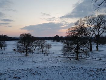 Scenic view of frozen lake against sky during winter