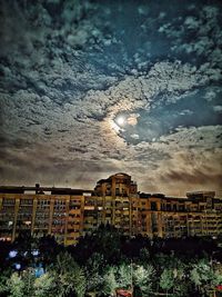 Buildings against sky at night