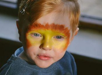 Close-up portrait of boy wearing face paint