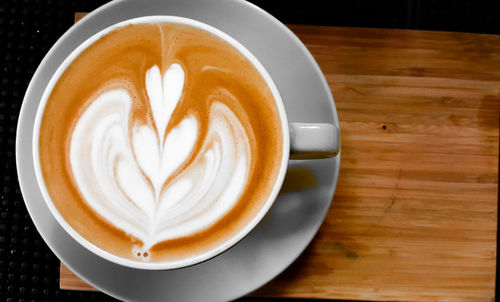 Close-up of cappuccino served on table