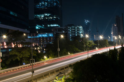 High angle view of light trails on road at night
