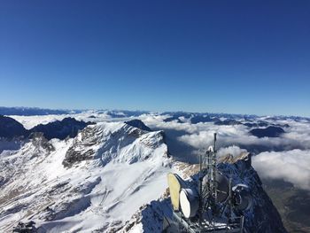 Scenic view of snow mountains against clear blue sky