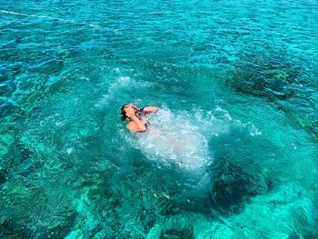 High angle view of man swimming in sea