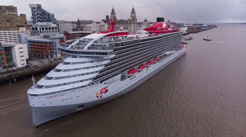 High angle view of ship moored on sea against buildings