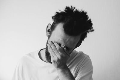 Portrait of young man against white background