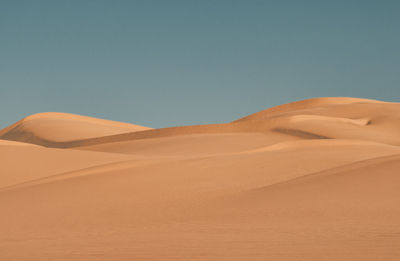 Scenic view of desert against clear sky