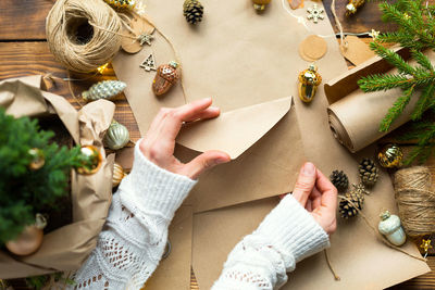 Cropped hands of woman holding christmas decorations