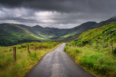 Road amidst mountains against sky