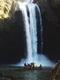 People in boat on river