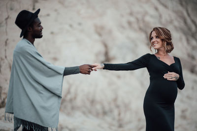 Side view of a smiling couple standing outdoors