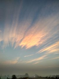 Low angle view of silhouette trees against sky at sunset