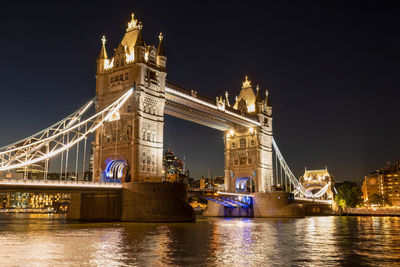 Illuminated tower bridge over the river thames at night
