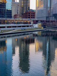 Bridge over river by buildings in city