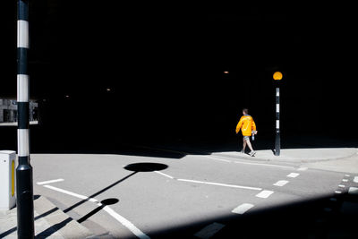 Rear view of people walking on footpath