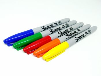 Close-up of multi colored pencils over white background