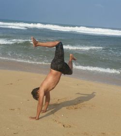 Full length of man on beach against sky