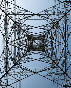 Low angle view of electricity pylon against clear sky