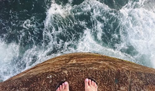 Low section of person on sea shore