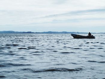 Man in boat against sky