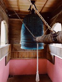 Low angle view of swing hanging on wall