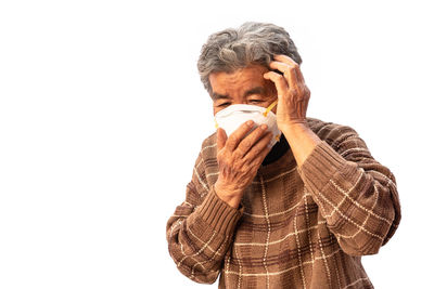 Portrait of man wearing mask against white background