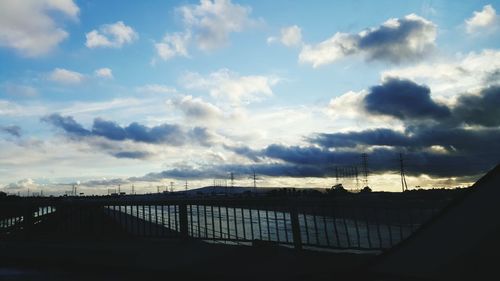 Silhouette of trees against cloudy sky