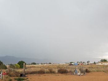 Panoramic view of agricultural field against clear sky