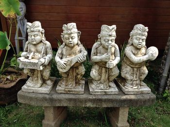 Buddha statue against brick wall