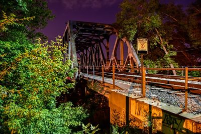 Railway bridge against sky at night