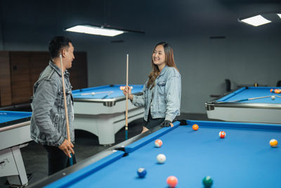 Portrait of woman playing pool