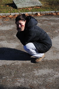 Portrait of young man on footpath