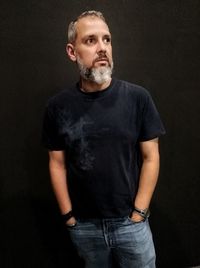 Portrait of mid adult man against black background