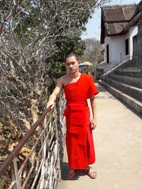 Portrait of man standing by railing