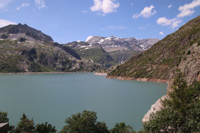 Scenic view of lake and mountains against sky