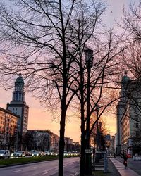 Statue in city at sunset