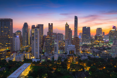 Aerial view of buildings against sky during sunset