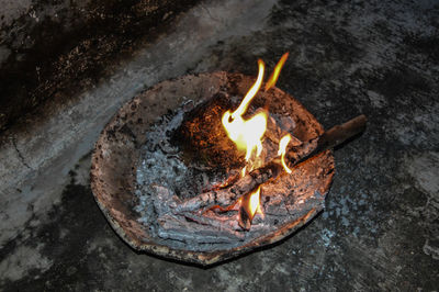 High angle view of fire on rock