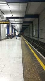 People walking on railroad station platform