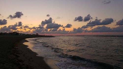 Scenic view of beach against sky during sunset