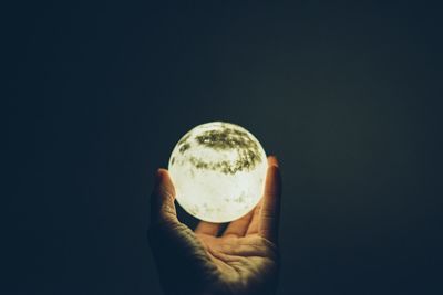 Close-up of hand holding glass ball