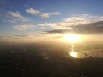 Aerial view of city against sky during sunset