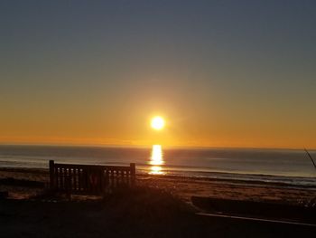 Scenic view of sea against clear sky during sunset