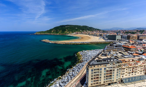 High angle view of cityscape by sea against sky