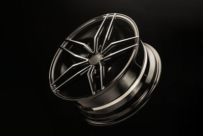 Close-up of alloy wheel against black background