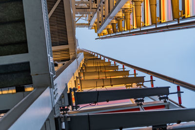 Low angle view of crane against sky