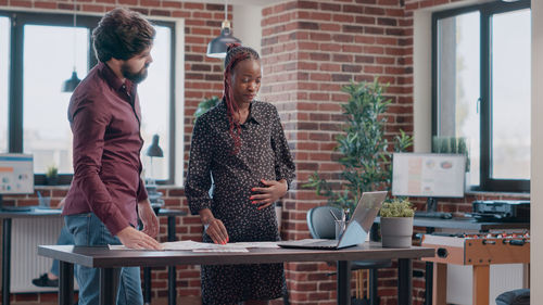 Side view of business colleagues working in office