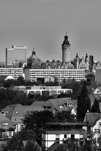 Buildings in city against clear sky