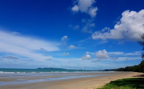 Scenic view of beach against blue sky