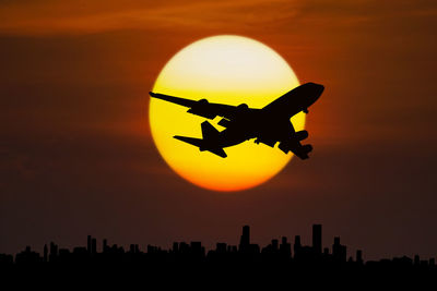 Silhouette cityscape against sky during sunset